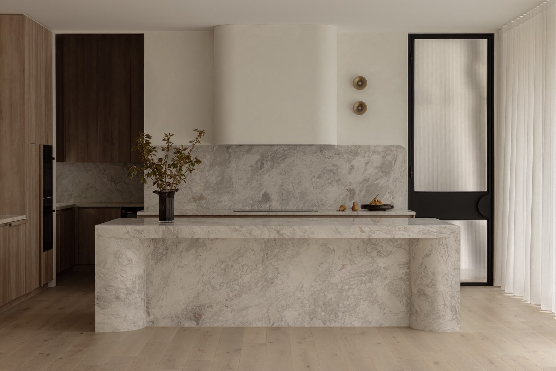 Alphington Residence — kitchen with stone island and steel-framed glass door