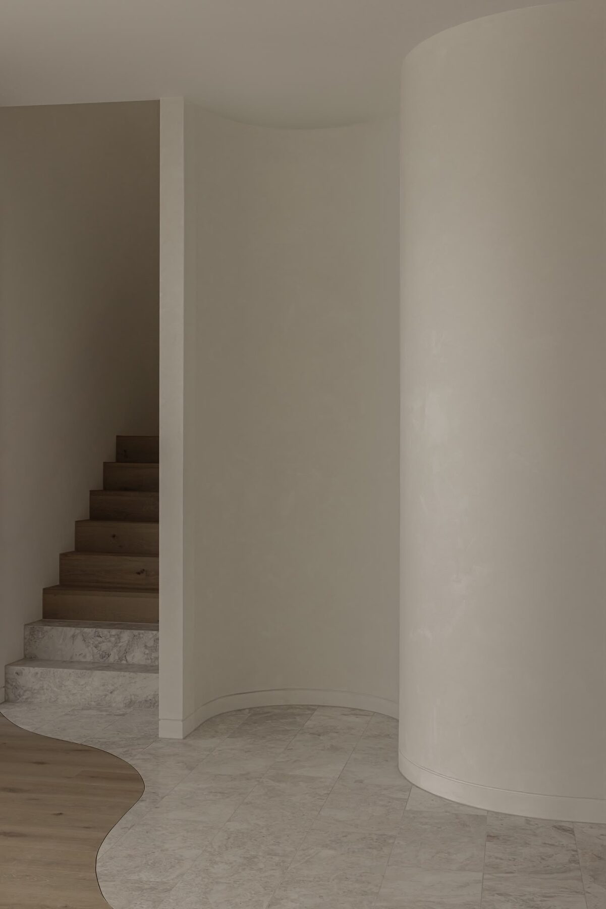 Alphington Residence — curved wall leading to stone staircase